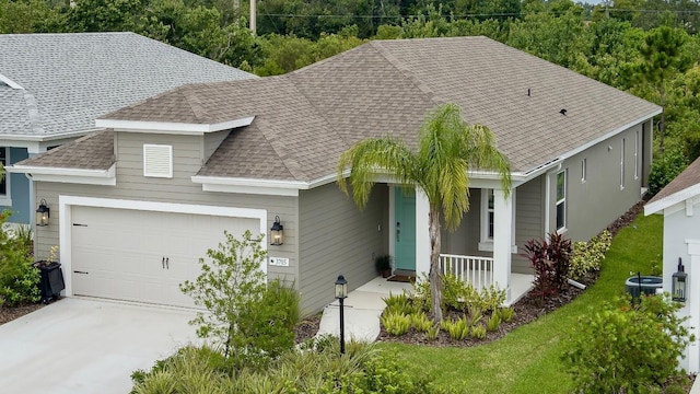 view of front of house with a garage, a porch, central AC, and a front lawn