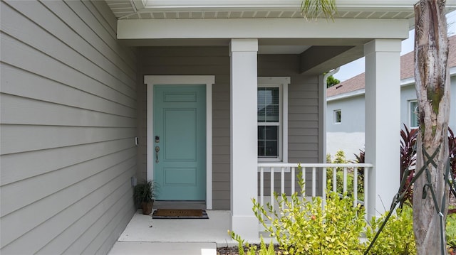 view of exterior entry with a porch