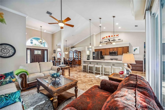 living area featuring high vaulted ceiling, visible vents, crown molding, and ceiling fan with notable chandelier