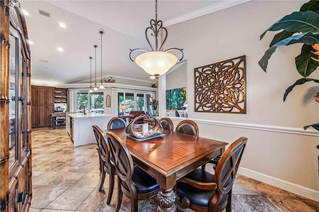 dining area featuring ornamental molding, lofted ceiling, french doors, and sink