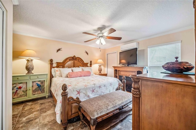 bedroom featuring ceiling fan, a textured ceiling, ornamental molding, and a wall unit AC