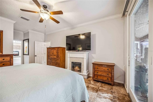 bedroom with ceiling fan, a textured ceiling, a fireplace, and ornamental molding