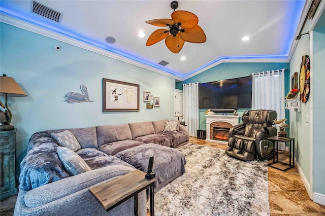 living room featuring ceiling fan, lofted ceiling, and ornamental molding