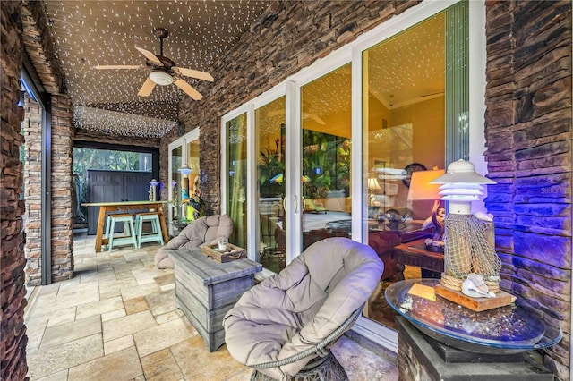 sunroom / solarium with lofted ceiling and ceiling fan