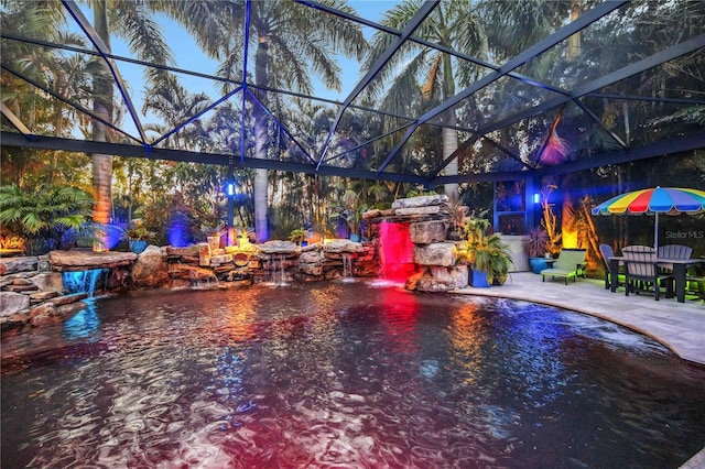 view of swimming pool featuring a patio and a lanai