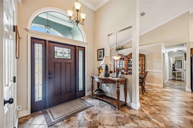 entrance foyer with a towering ceiling, an inviting chandelier, visible vents, and ornamental molding