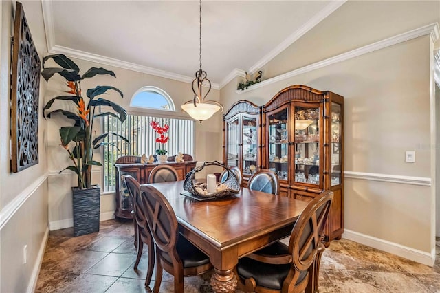 dining area with baseboards, ornamental molding, and vaulted ceiling