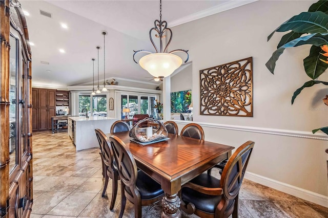 dining area featuring baseboards, visible vents, vaulted ceiling, and crown molding