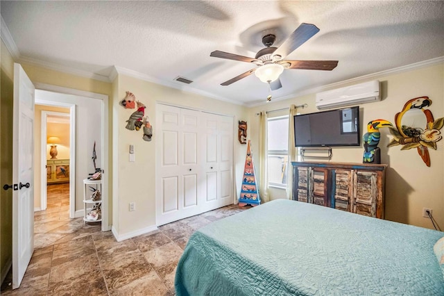 bedroom with a textured ceiling, a wall unit AC, visible vents, and crown molding