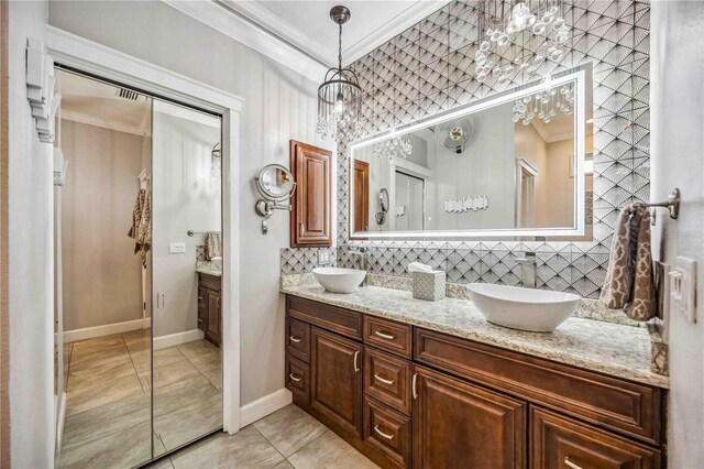 full bath with double vanity, backsplash, a sink, and crown molding