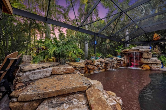 exterior space featuring a patio area, a fireplace, and a lanai