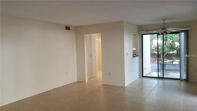 tiled spare room with ceiling fan