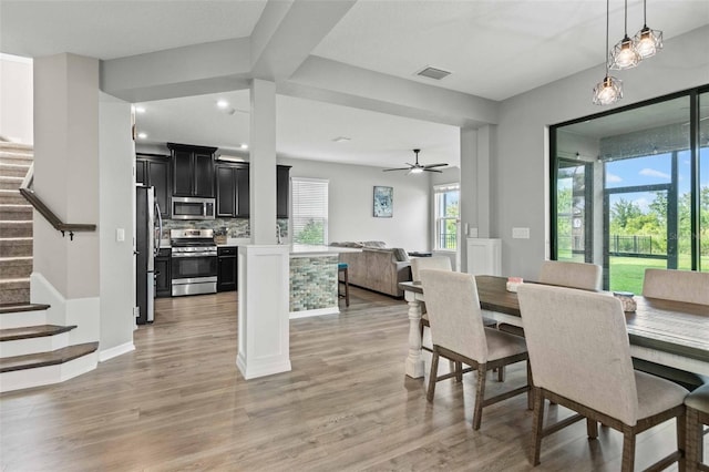 dining room with ceiling fan and light hardwood / wood-style flooring