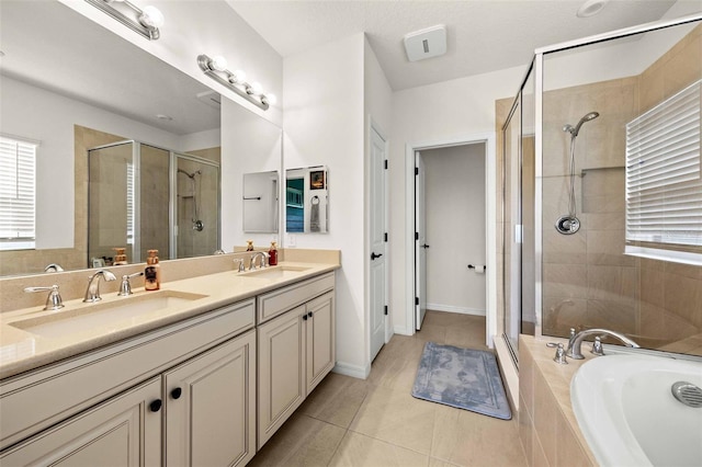 bathroom with tile patterned floors, double vanity, and independent shower and bath