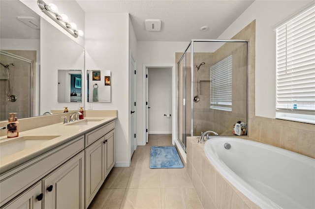 bathroom with shower with separate bathtub, dual bowl vanity, a textured ceiling, and tile patterned floors