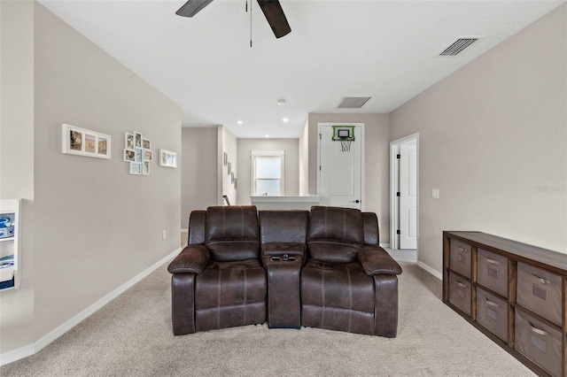 carpeted living room with ceiling fan