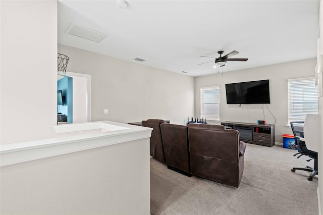 carpeted living room featuring ceiling fan