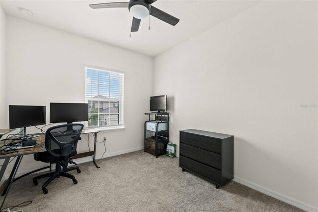 carpeted home office with ceiling fan