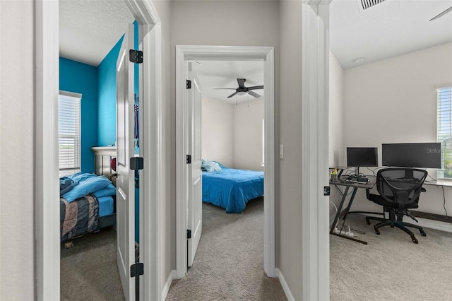 office area featuring ceiling fan, a wealth of natural light, and light colored carpet