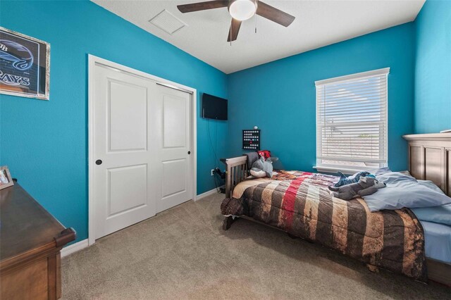 carpeted bedroom with ceiling fan