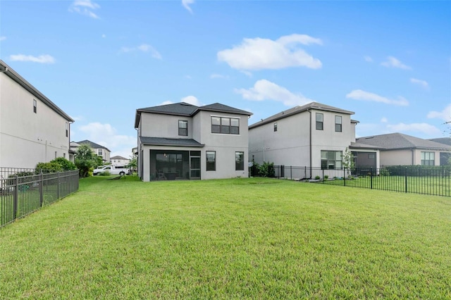 rear view of property with a lawn