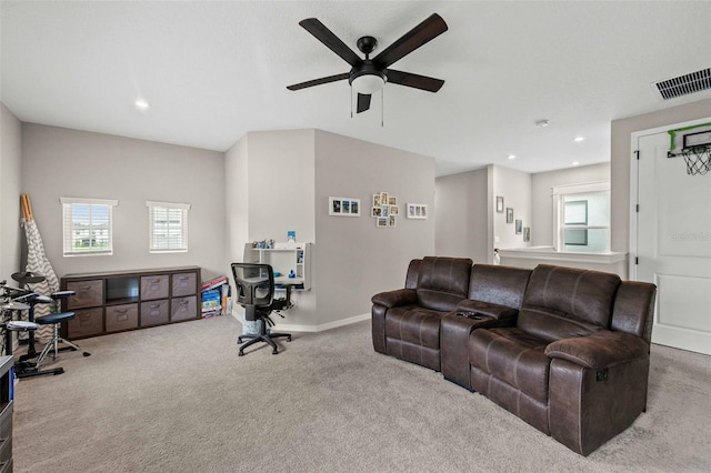 carpeted living room with ceiling fan