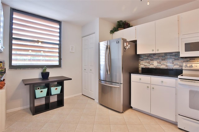 kitchen featuring decorative backsplash, light tile patterned floors, white appliances, and white cabinetry