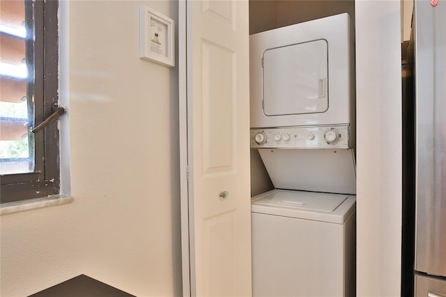 laundry area with stacked washing maching and dryer