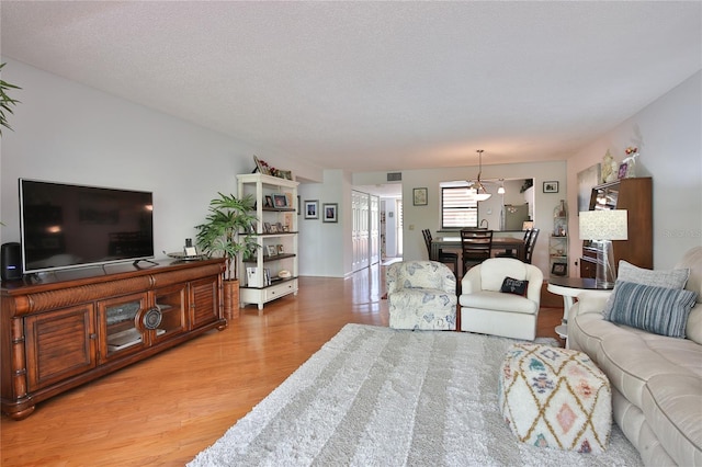 living room with a textured ceiling and hardwood / wood-style floors