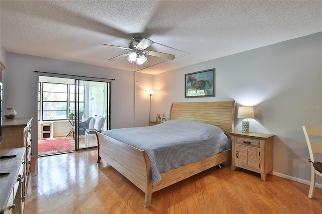 bedroom with access to outside, a textured ceiling, ceiling fan, and light hardwood / wood-style floors