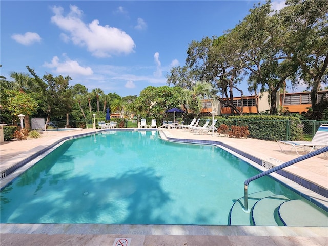 view of swimming pool with a patio area