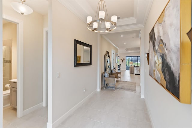 hallway featuring light tile patterned floors, a chandelier, and ornamental molding