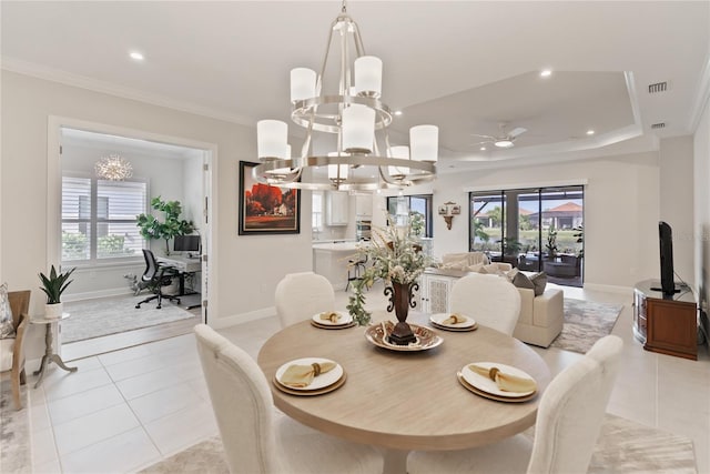 tiled dining space with plenty of natural light, crown molding, and ceiling fan with notable chandelier