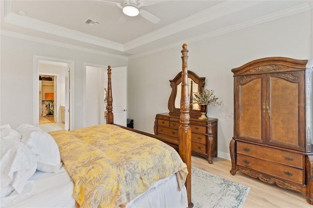 bedroom featuring light wood-type flooring, ceiling fan, and crown molding