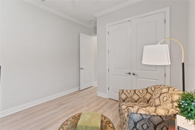 living area featuring ornamental molding and light hardwood / wood-style flooring