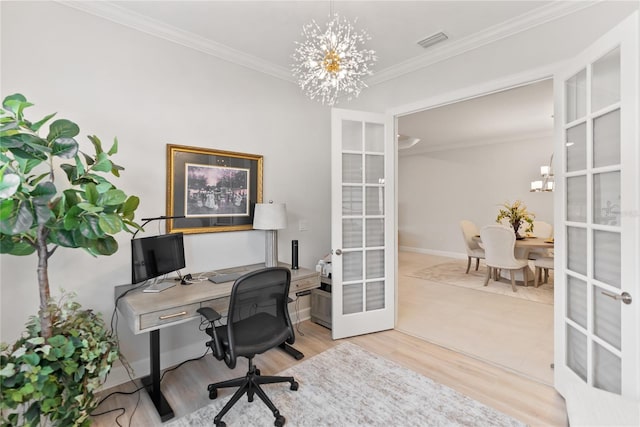 home office with french doors, light hardwood / wood-style floors, an inviting chandelier, and ornamental molding