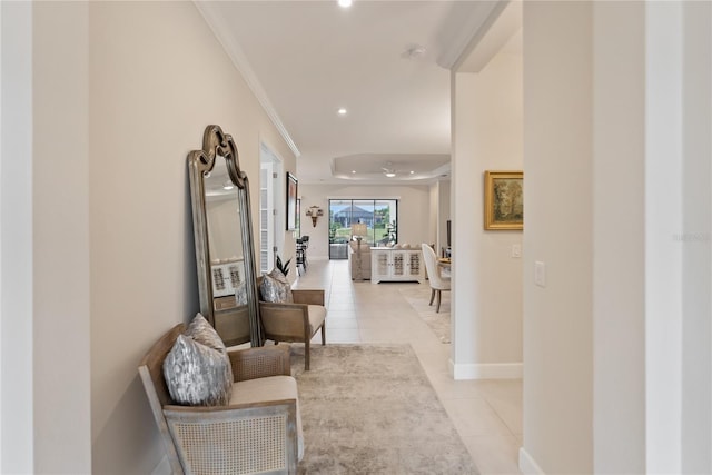 hallway featuring light tile patterned flooring and crown molding