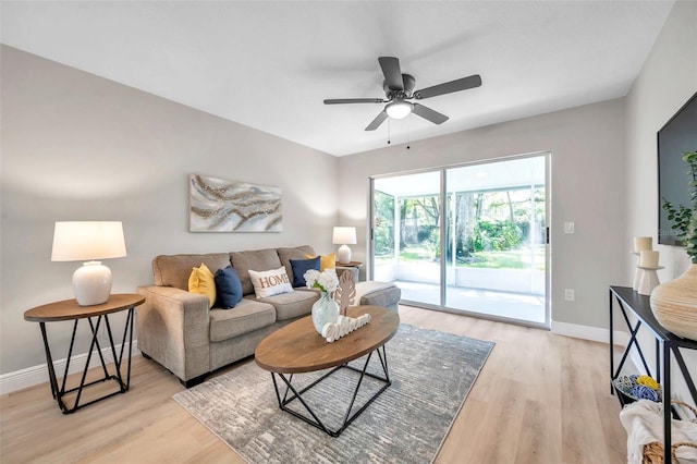 living room with light wood-type flooring and ceiling fan