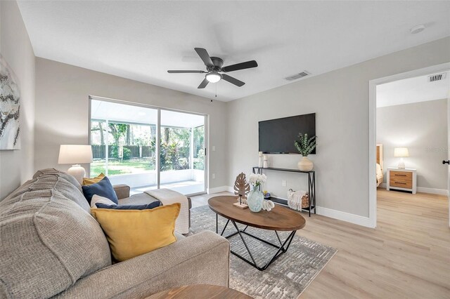 living room with ceiling fan and light wood-type flooring