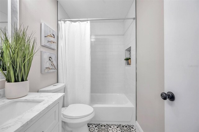 full bathroom with toilet, shower / tub combo with curtain, vanity, and tile patterned floors