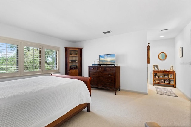 bedroom featuring light carpet, visible vents, and baseboards