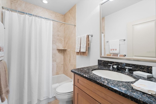 bathroom featuring toilet, shower / bath combo with shower curtain, and vanity