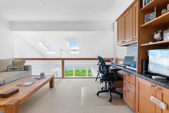 office featuring light carpet and lofted ceiling with skylight