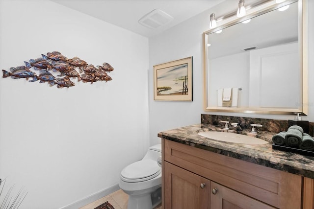 bathroom with toilet, vanity, tile patterned flooring, and visible vents