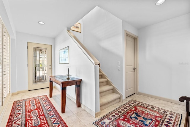 entrance foyer with baseboards, light tile patterned floors, stairway, and recessed lighting