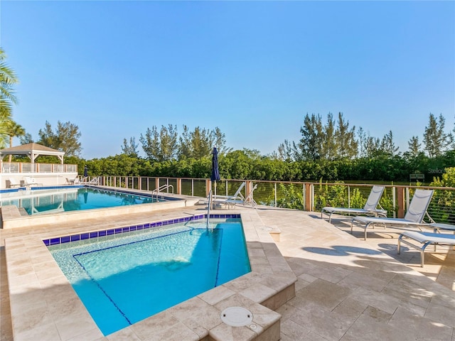 pool featuring a patio area and fence