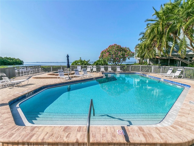 community pool featuring a patio area and fence