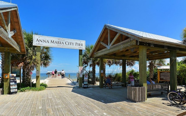 view of community featuring a view of the beach, a gazebo, and a deck with water view