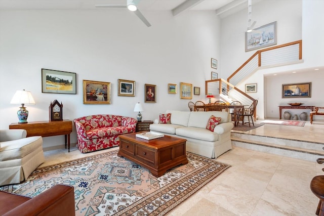 living room featuring beam ceiling, ceiling fan, and high vaulted ceiling