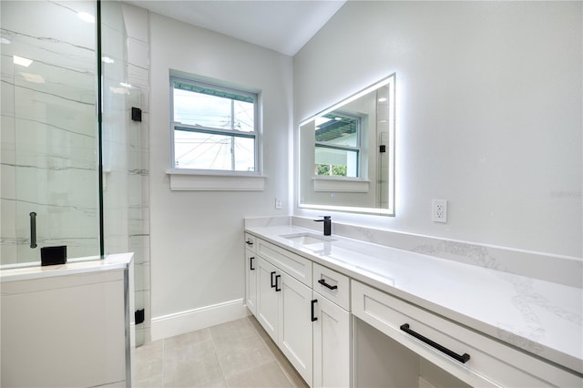 bathroom featuring vanity, a shower with door, and tile patterned flooring